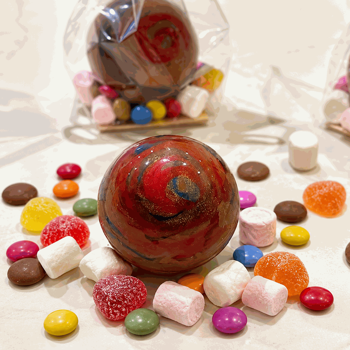 Hand-decorated smashable milk chocolate Christmas bauble filled with sweets