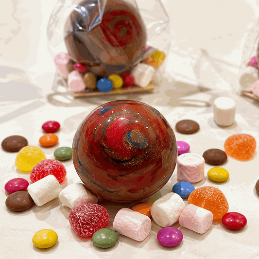 Hand-decorated smashable milk chocolate Christmas bauble filled with sweets
