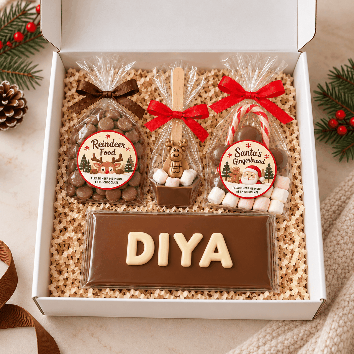 Personalised Christmas Eve chocolate box with named bar, gingerbread and hot chocolate stirrer